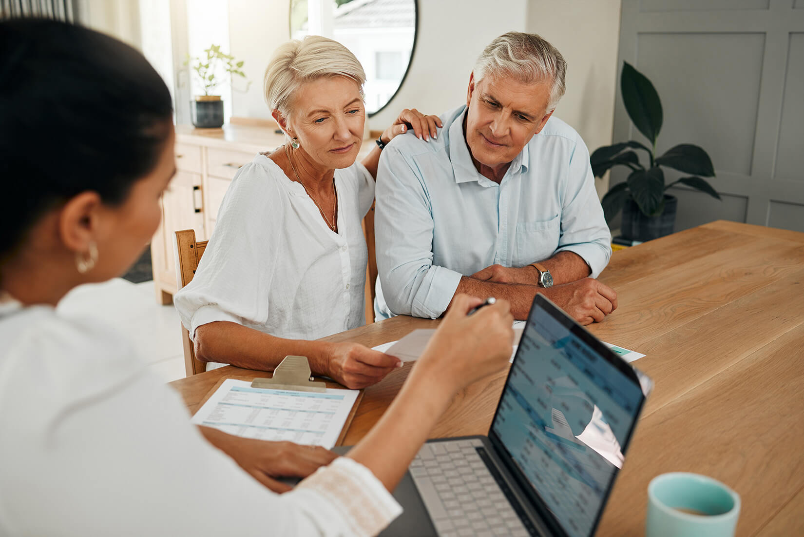 retired couple reviewing finances with advisor retired couple reviewing finances with advisor