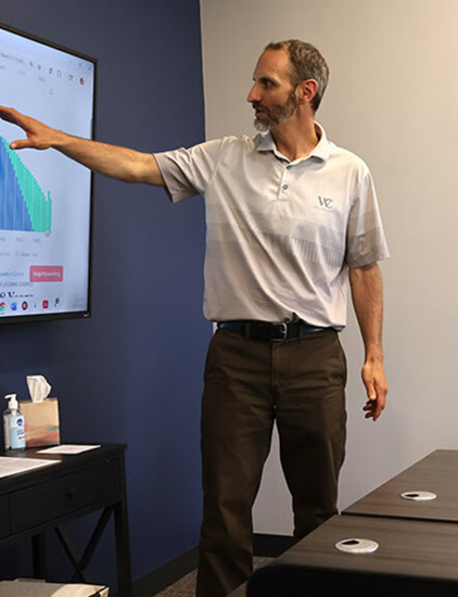 Digital marketing strategist reviewing SEO performance data on a conference room display